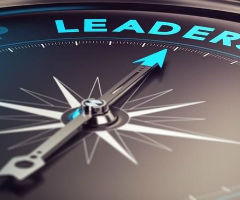 Compass with leadership at top and dial pointing it.