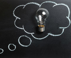 A light bulb within a thought bubble.