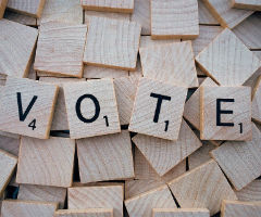 The word, "Vote" on Scrabble tiles