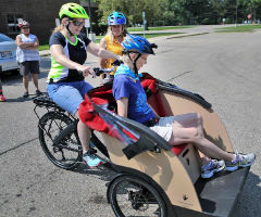 Carolyn Brandeen rides in the front as Cathy Blackburn begins to pedal an electronically assisted three-wheeled bike during a training session in Janesville.