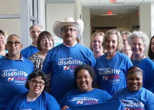 Group people posing together in Wisconsin Disability Vote Coalition t-shirts and smiling