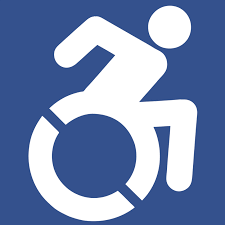 Outline of person moving in wheelchair, made to look like the universal symbol for disability access